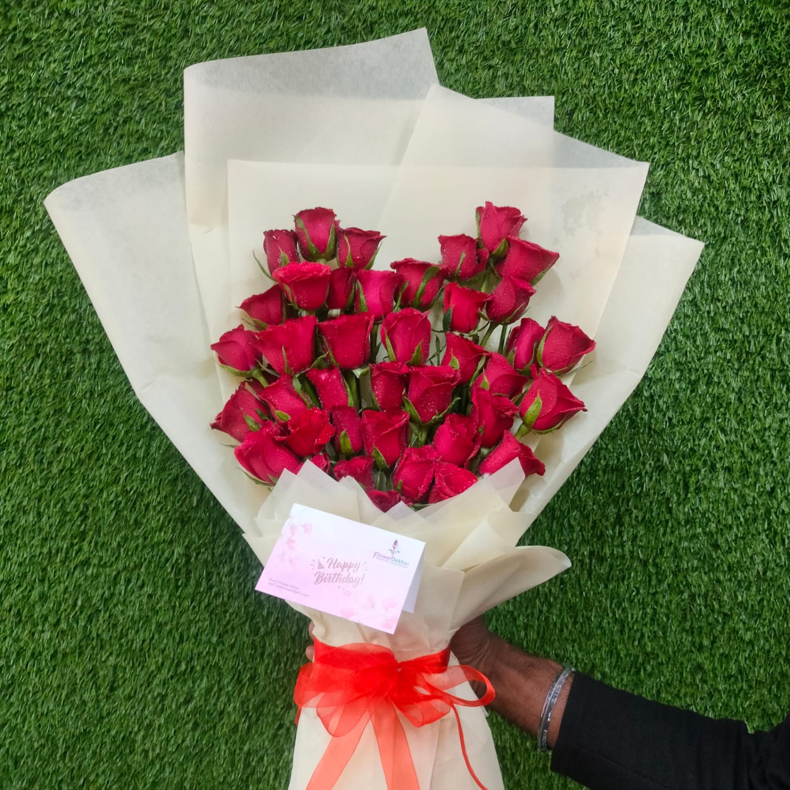 50 red rose bouquet wrapped in white paper – FlowerDekho