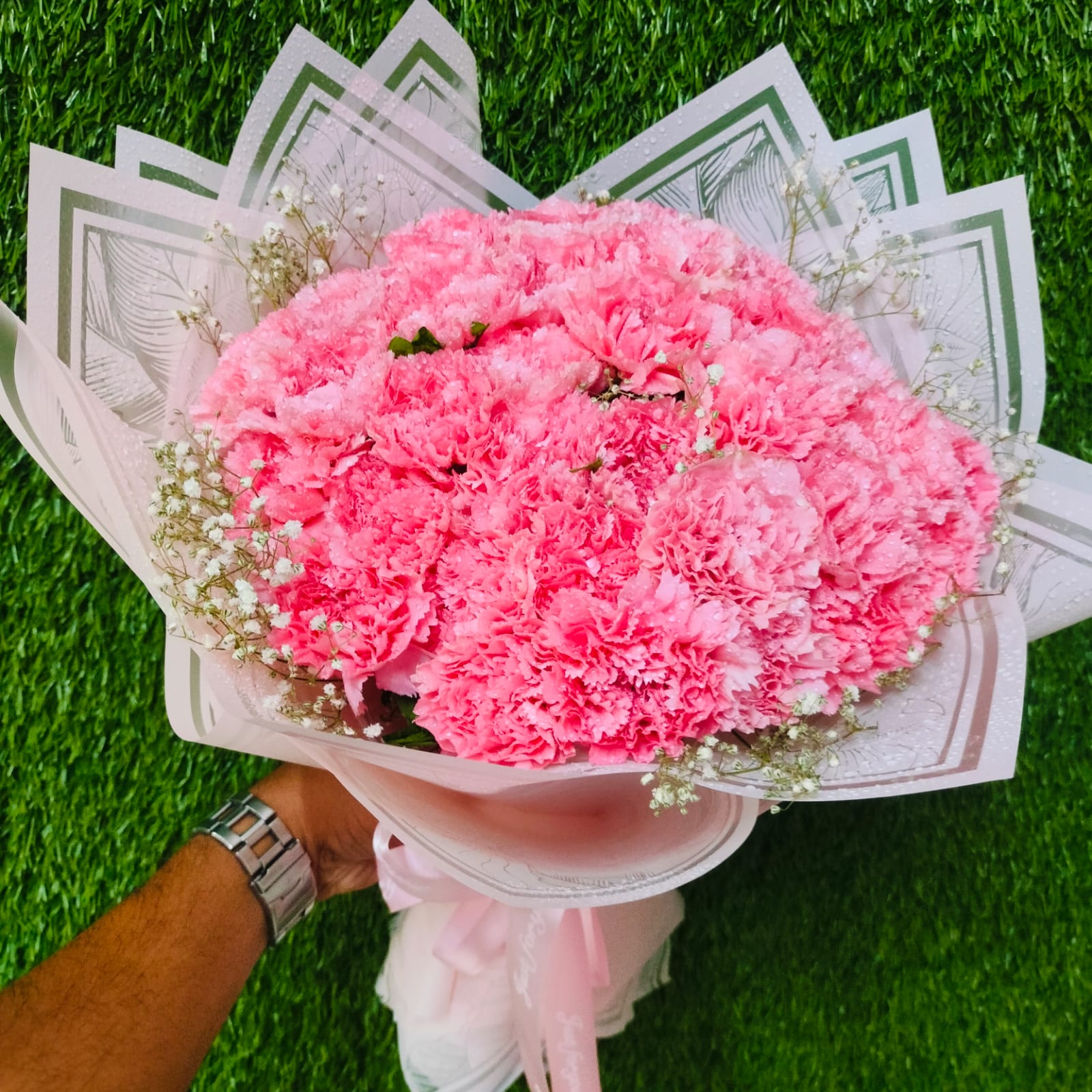 Pink carnation bouquet with white filler flowers – FlowerDekho