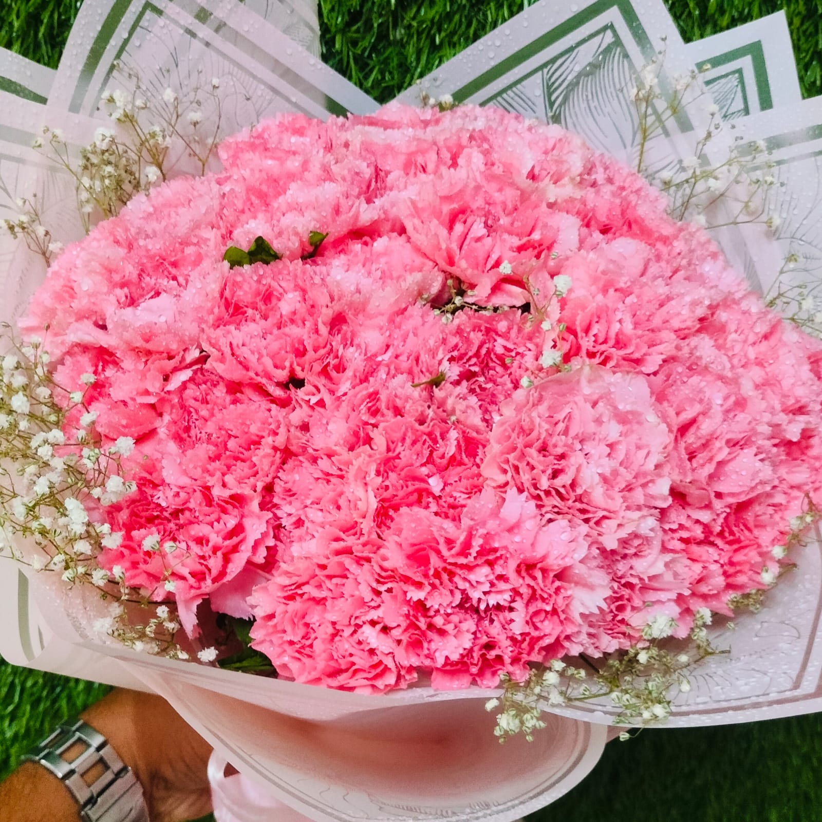 Pink carnation bouquet with white filler flowers – FlowerDekho